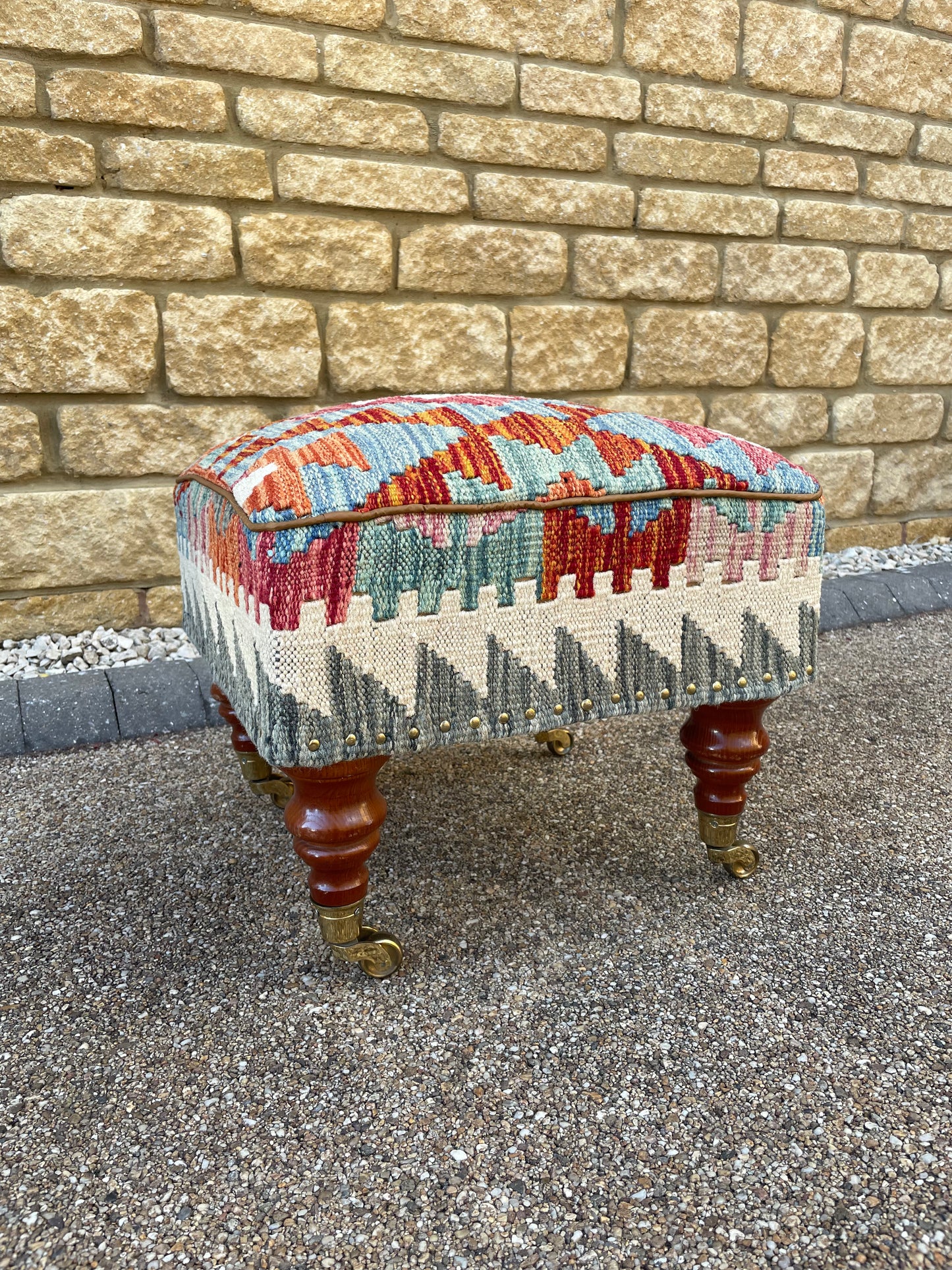 Kilim upholstered Ottoman/Stool on Brass Castors